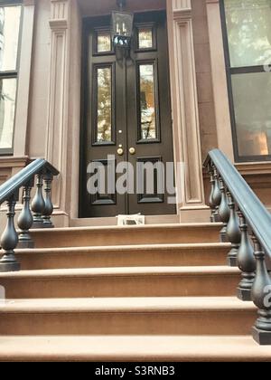 Brownstone New York City. Front steps with newspaper on doorstep Stock Photo