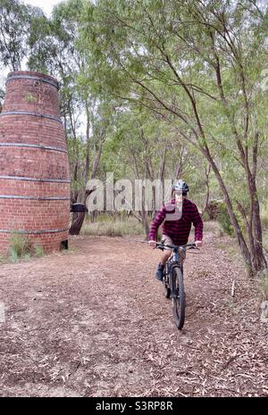 Cyclist riding mountain bike on Chimney trail Wooditjup National Park Margaret River Western Australia Stock Photo