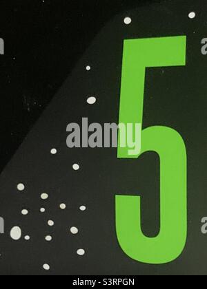 Green number 5 on black background Stock Photo