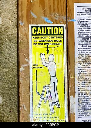 Caution sign on wooden ladder Stock Photo