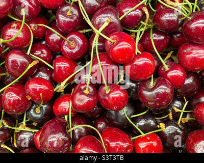 A pile of fresh cherries on sale in a supermarket l. Stock Photo