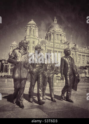The world famous and iconic Fab Four - a bronze statue sculpture of The Beetles - McCartney, Star, Harrison & Lennon. Situated at the Pier Head in Liverpool, England. Photo ©️ COLIN HOSKINS. Stock Photo