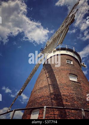 Looking up at the sails of a windmill against the sky. The windmill, known as John Webb’s windmill is located in Thaxted in Essex and was built in 1804 to grind flour. It is no longer a working mill. Stock Photo