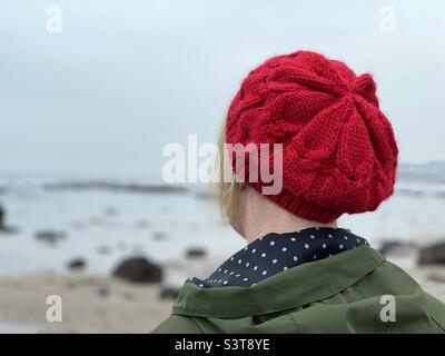 Rear view of woman wearing a red knit hat Stock Photo