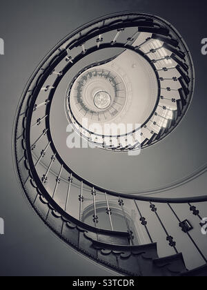 The view from the bottom of a spiral staircase, looking up. There’s something satisfying about geometric shapes! Photo ©️ COLIN HOSKINS. Stock Photo