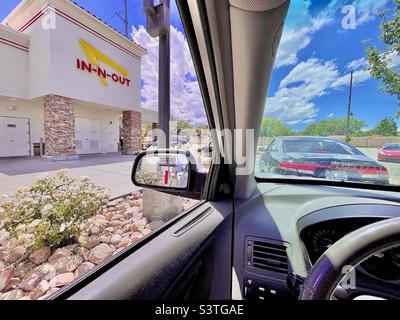 A view from inside a car waiting at the drive-thru at an In-n-Out Burger fast food restaurant in Utah, USA. Stock Photo