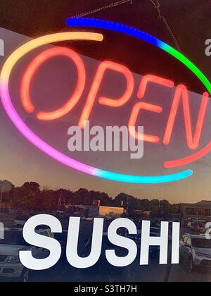 Colorful neon OPEN sign in SUSHI restaurant window Stock Photo