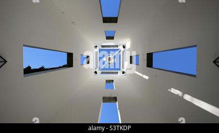 LOS ANGELES, CA, OCT 2021: blue sky through open windows, view looking up at architectural detail of building near entrance to the Skirball Cultural Center Stock Photo