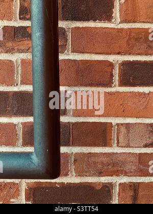 Brick Wall. Closeup portion of red brick wall with black bar Stock Photo