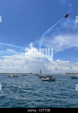 Blue Angels jet flying over boats at the Pensacola Beach air show Stock Photo