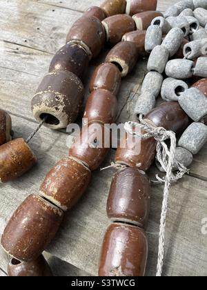 Strings of Japanese ceramic and lead fishing weights Stock Photo