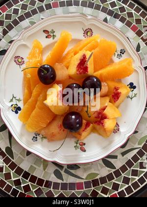 Fresh fruit plate of nectarines, cherries and oranges. Stock Photo