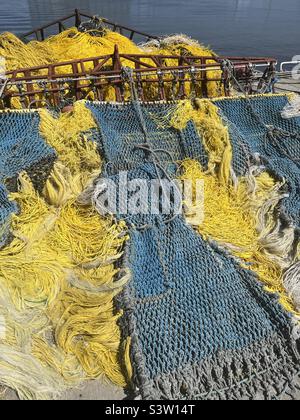 Yellow and blue commercial fishing nets Stock Photo