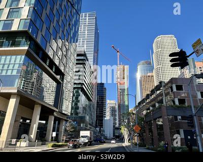 LOS ANGELES, CA, FEB 2022: new skyscraper under construction near Fig at 7th retail area, surrounded by other skyscrapers, with new hotel complex in foreground, Downtown Stock Photo