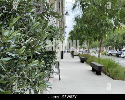 LOS ANGELES, CA, APR 2022: view along sidewalk at The Row, redeveloped urban site in Downtown Produce District. Focus on foreground with anonymous person in distance Stock Photo