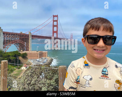 A young boy posing for a portrait in front of The Golden Gate Bridge in San Francisco in California, USA Stock Photo