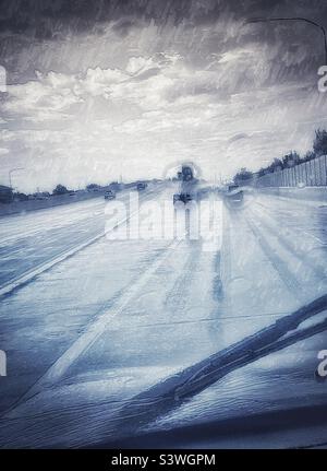 Driving through monsoonal rains in late summer in Utah, USA. Image has been made painterly and has been otherwise altered for artistic effect. Stock Photo