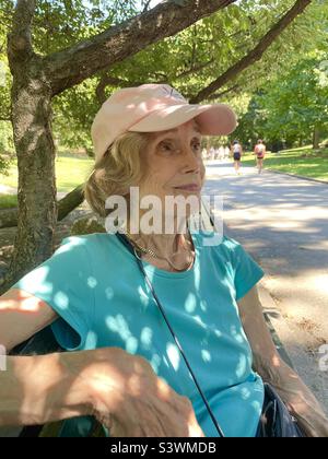 Smiling senior woman in a park on a sunny day Stock Photo
