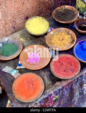 Bowls of colourful natural dyes used in the dyeing of wool in the Souks market, Marrakesh, Morocco, North Africa. Stock Photo