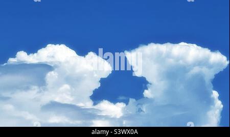 Building cumulonimbus clouds billowing above the Wasatch Mountain Range in Utah, USA bordering Salt Lake City on the east, on a hot summer day. Stock Photo