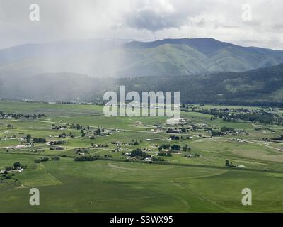 Aerial view of lush green fields and dense forests set against the ...