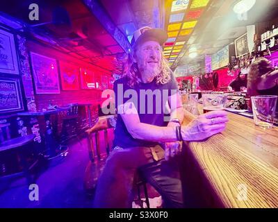 A man has a drink at a rock bar in Denver Stock Photo
