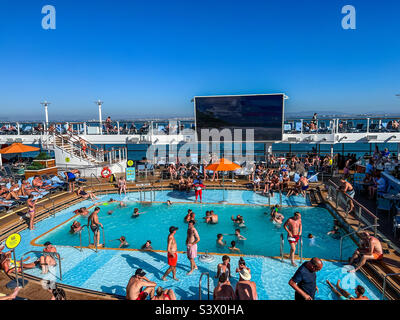 Royal Caribbean Anthem of the Seas cruise outdoor swimming pool with many holidaymakers Stock Photo