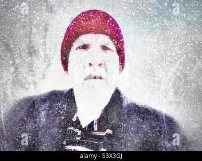 A selfie (Titled: Old Man Winter) on a heavy snow day in Utah, USA. Some digital snowfall has been added, but the cold chill and the weight of the snow in my shovel was very real. Stock Photo