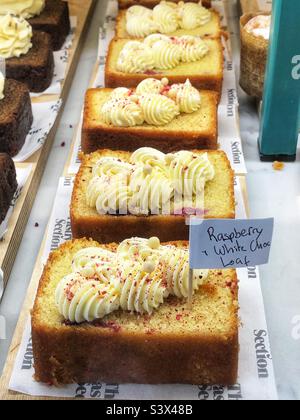 Cake Raspberry and white chocolate loaf in bakery window Stock Photo
