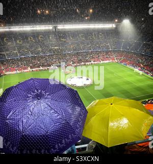 Fans take cover and the stands empty at Camp Nou Stadium as a huge thunderstorm hits a Barcelona FC Champions League match against Olympiakos just as it’s about to kick off Stock Photo