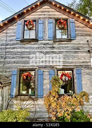 A rustic cabin building that is one of the many stores and shops within Gardner Village, a shopping and event venue. Here, this building is decorated for the upcoming Halloween season and WitchFest. Stock Photo