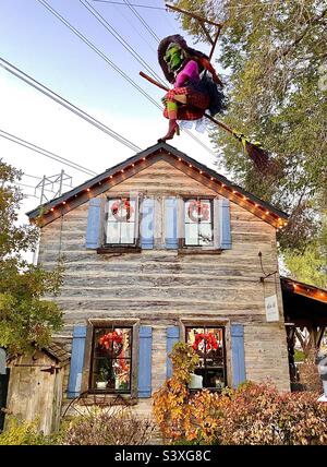 A rustic cabin building that is one of the many stores and shops within Gardner Village, a shopping and event venue. Here, this building is decorated for the upcoming Halloween season and WitchFest. Stock Photo