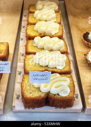 Lemon Drizzle cake in a bakery shop window Stock Photo