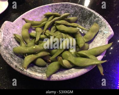 Plate of salted soya beans Stock Photo