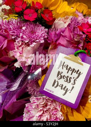 “Happy Boss’s Day!” card and bouquet of flowers. Stock Photo
