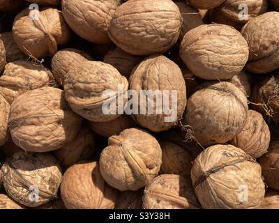 a heap of brown walnuts Stock Photo