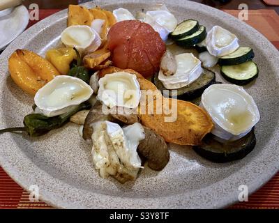 Roast vegetables with goats cheese and honey Stock Photo