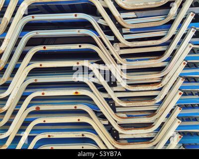 Stacked sun beds at end of the season Stock Photo