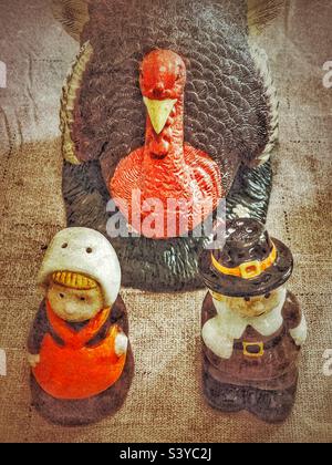 Turkey decor centerpiece and seasonal pilgrim salt and pepper shakers on a tabletop in Utah, USA near the Thanksgiving holiday season. Grunge filter added digitally for a rustic and vintage look. Stock Photo