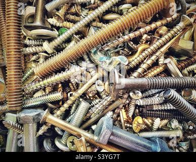 Our toolbox has a small plastic box filled with miscellaneous hardware, the assortment includes various types of screws, nuts, bolts, etc. This close view makes an interesting background and abstract. Stock Photo