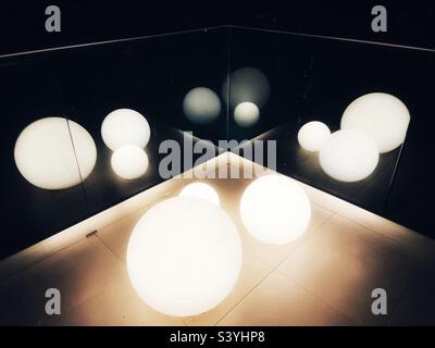 Light globes reflected in glass Stock Photo