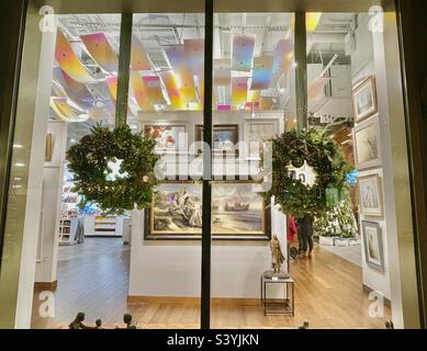 In downtown Salt  Lake City, Utah, USA during the Christmas season. Here, a look inside the decorated interior of Deseret Bookstore, a local long-standing business, after dark from the outside. Stock Photo