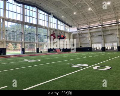 Chestnut Hill, Massachusetts, USA - August 28, 2022: Boston College, indoors football athletic field with photo of football player on the wall (editorial) Stock Photo