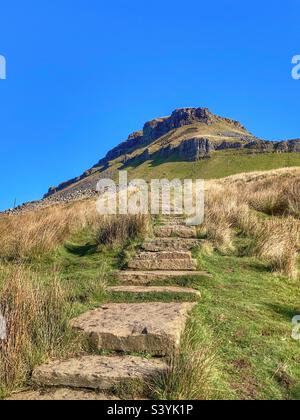 Steps walking towards Pen-y-Ghent mountain in the Yorkshire Dales Stock Photo