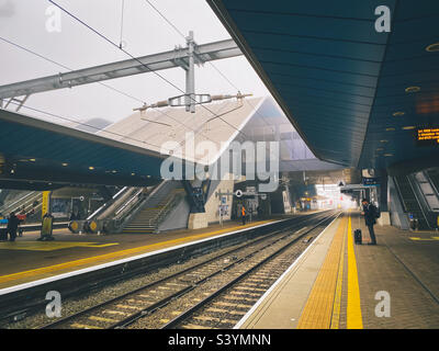 Waiting on the platform at Reading Railway Station for a train to arrive. Stock Photo