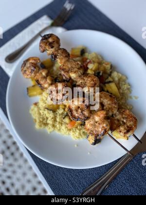 Shrimp kabobs with grilled pineapple and mango rice. Stock Photo