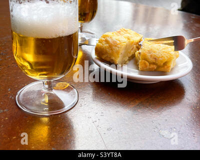 Pincho de tortilla, Spanish omelet with glass of beer. Spain. Stock Photo