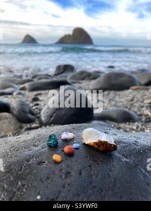 Brightly colored pebbles on the seashore. Stock Photo