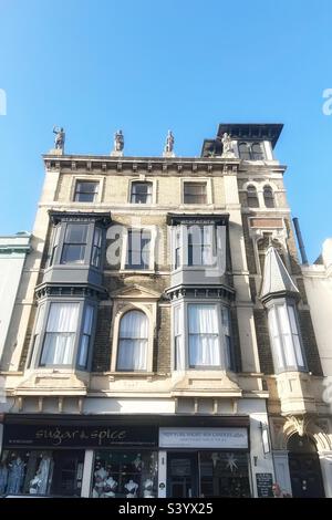 60 Union Street, Ryde, Isle of Wight is a Grade II Listed Building by Historic England noted for Osbourne Tower and the figures on the rooftop described as neo antique statues. Dated 1865 - Victorian Stock Photo