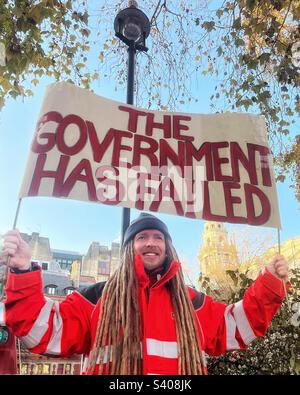 Demonstrator holds. banner “The Government has failed” in Parliament Square, Westminster, London at the CWU postal trade union rally in December 2022 Stock Photo